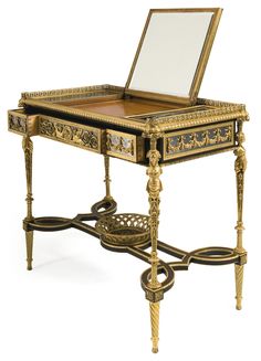 an ornately decorated desk with a mirror on top