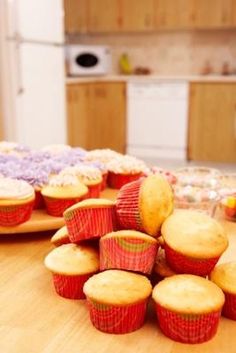 cupcakes and muffins on a table in a kitchen