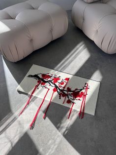 a living room with two couches and a rug that has blood on the floor