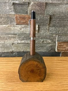 a pen sitting on top of a piece of wood