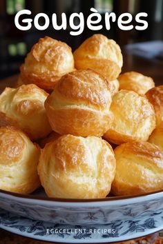 a plate full of baked goods with the words gougeres on it