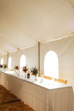 a long table is set up in a tent