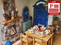 there is a small table with tea cups on it in front of a blue door