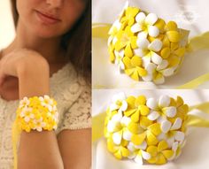 the woman is wearing a yellow and white bracelet with flowers on it's wrist