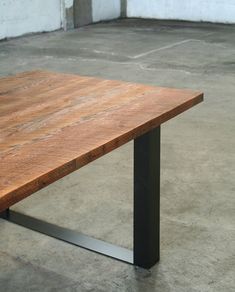 a wooden table sitting on top of a cement floor