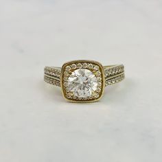 An engagement ring with brilliant clear cubic zirconia stones in 9K yellow gold. The ring features a round brilliant cut stone in the center with smaller stones set around him in a halo, with two more rows of paved stones on each shoulder.  The ring is in excellent vintage condition. Ring is size 6 US and resizable. It has multiple markings inside the band including 375 but are quite faint. Please inquire for a quote. Further details are as follows: Stone: Round cut CZ stone, several round cut s Gold Diamond Ring With Round Stone For Anniversary, Gold Diamond Ring For Anniversary With Round Stone, Gold Diamond Ring With Vs Clarity And White Topaz, Gold Diamond Ring With Cubic Zirconia Center Stone, Gold Diamond Ring With Vs Clarity And Round Cut, Gold Diamond Ring With Diamond Accents, Yellow Gold Diamond Ring With Center Stone, Dazzling Gold Diamond Ring With Center Stone, Gold Diamond Ring With Accents