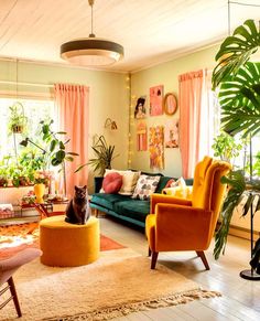 a living room filled with furniture and lots of plants