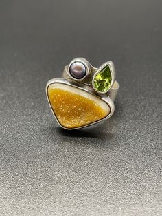 Sterling Silver Peridot Pearl & Druzy Designer Ring Size 6 but it can be sized to your needed size for an additional $35. Add a week to shipping time if needing it sized. Message me before purchasing if you are requesting sizing. Signed Obsidian 925 Stunning ring. Please Read Below Please check out my other items! Tons of jewelry coming up for sale. I love to combine shipping on multiple items, and am happy to ship internationally. International bidders, please contact me with your location for Peridot Ring Silver, Peridot Silver Rings, Peridot Rings With Natural Stones For Gifts, Modern Silver Peridot Jewelry, Unique Multi-stone Citrine Rings, Classic Silver Peridot Rings, Unique Multi-stone Peridot Rings, Silver Peridot Rings With Polished Finish, Natural Gemstone Ring