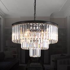 a chandelier hanging from the ceiling in a living room