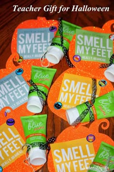 small orange and green candy bags on top of each other with the words smell my feet written on them