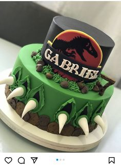 there is a green cake with white and black frosting on the top that says garbie