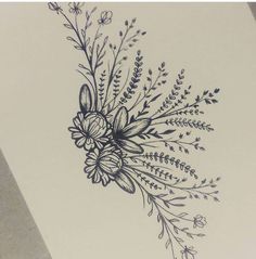 a drawing of flowers and leaves on a piece of paper