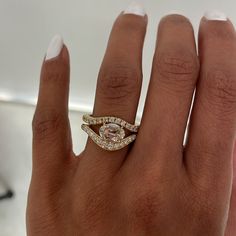 a woman's hand with a diamond ring on top of her finger and an engagement band