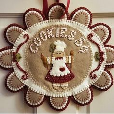 a christmas ornament hanging on a door with a santa clause decoration in the center