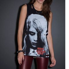 This Tunic Style Sleeveless T-Shirt Features A Front Screen Of The Signature Night Of The Living Dead Art. Cut Detailing At Shoulders, Breast Areas And Hips. Those Variously Sized Pinhole Cuts Give This Shirt An Extra Edgy Touch. Hematite Pyramid Stud Accents Are Under Neck And Along Lowered Pits. Show Your Passion For Night Of The Living Dead With This Destroyed Sleeveless T-Shirt. Made In Usa! Item Condition: New With Tag. Size Pit To Pit Neck To Bottom (On The Back) M 19" 26" L 20" 27 Edgy Halloween Concert Top, Edgy Top For Halloween Concert, Edgy Tops For Concerts, Edgy Skull Print Sleeveless Tank Top, Emo Style Top For Halloween Night Out, Edgy Black Tank Top For Night Out, Edgy Tank Top For Streetwear, Halloween Grunge Tops For Night Out, Black Punk Tank Top