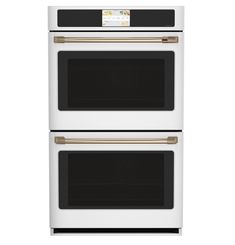 two white ovens side by side with the door open and one in gold trim