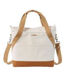 a white bag with brown straps on the bottom and side pockets, in front of a white background