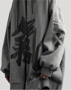 Tokyo streetwear at its best: discover the fusion of tradition and modernity with our Kanji hoodie. Unveiling the Japanese Kanji Hoodie, a celebration of urban chic influenced by the aesthetics of Japanese culture. This bold, black oversized zip-up hoodie for men, adorned with elegant calligraphic Kanji, embodies an intense appreciation for Japan's artistic and philosophical nuances. Envelop yourself in this distinctive piece, letting it become a part of your identity as it seamlessly communicat Harajuku Style Hooded Jacket For Winter Streetwear, Winter Harajuku Style Hooded Streetwear Jacket, Harajuku Style Cotton Outerwear For Streetwear, Cotton Harajuku Outerwear For Streetwear, Gray Urban Hooded Jacket For Streetwear, Urban Gray Hooded Jacket For Streetwear, Oversized Hoodies Aesthetic, Tokyo Streetwear, Apocalyptic Clothing