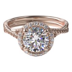 a rose gold engagement ring with a round diamond center surrounded by pave set diamonds