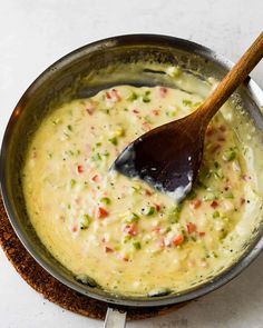 a wooden spoon in a pot filled with soup