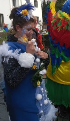 two women dressed in colorful costumes standing next to each other