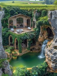 the house is surrounded by greenery and has a waterfall running into it's pool