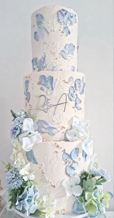 a wedding cake with blue and white flowers