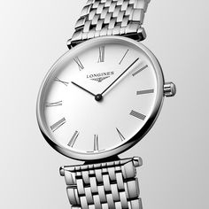 The Fascination of Timeless Style, Launched in 1992, La Grande Classique de Longines has played a major role in forging the reputation of the winged hourglass brand. This range is a symbol of Longines’ classic elegance and timeless sophistication, and stands out thanks to its very slim profile and wide palette of versions. Classic Round Dial Jewelry Watch For Gift, Timeless Jewelry And Watches With Polished Round Dial, Timeless Jewelry And Watches With Polished Finish, Timeless Watch With Subdials For Anniversary, Classic Timeless Design Watch For Gift, Formal White Gold Watch With Timeless Design, Timeless Anniversary Watch With Subdials, White Gold Watches With Timeless Design For Formal Occasions, Timeless Jewelry With Subdials And Round Dial