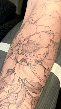 a woman's arm with flowers on it