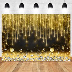 an image of a gold and black backdrop with sparkles on the floor in front of a brick wall