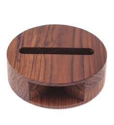 a wooden object with a hole in the middle on a white background, it is made out of wood