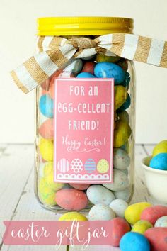 a jar filled with easter eggs on top of a table