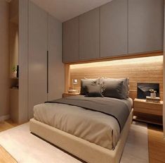 a large bed sitting in the middle of a bedroom next to a wall mounted cabinet