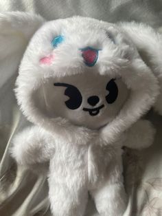 a white stuffed animal with blue eyes and wings