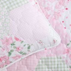 a pink and green floral quilted bed spread