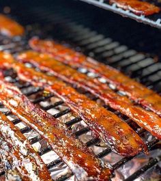 bacon is cooking on the grill with other food items