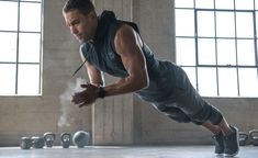 a man in grey shirt and shorts doing push ups