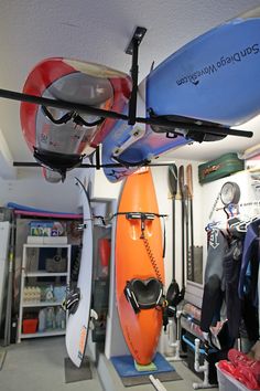 there are several surfboards hanging from the ceiling in this shop, and one is upside down