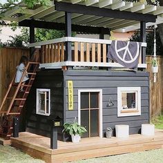 a small house made out of wood with a deck and stairs leading to the roof