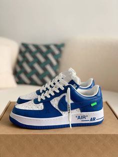 Embrace iconic style with these statement-making sneakers inspired by the legendary Louis Vuitton x Nike Air Force 1 collaboration. The vibrant blue leather upper, accented with the signature Louis Vuitton monogram, exudes luxury and street-style cool. Off-White™-inspired details add a contemporary edge, like the quoted "AIR" branding and exposed stitching. Step into the spotlight with these coveted kicks that blend high-fashion and sneaker culture. Your order arrives in a branded shoe box, comp Air Force 1 Louis Vuitton, Sneaker Culture, Baskets Nike, Iconic Style, Bhutan, Blue Sneakers, Air Force 1 Low, Vibrant Blue, Botswana