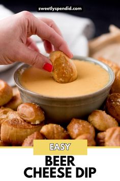 a person dipping some kind of food into a bowl with the words easy beer cheese dip