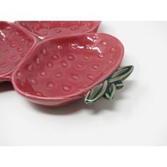 two strawberry shaped dishes sitting on top of each other