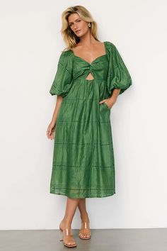 Elevate your semi-formal wardrobe with this flattering green midi dress, featuring feminine details like a sweetheart neckline, twist bust, and intricate green embroidery. Designed with puff sleeves, a self-tie back detail, and functional side pockets, this dress offers both elegance and comfort. Green Ruched Midi Dress, Green Ruched Midi Dress For Garden Party, Green Mid-length Dress For Date Night, Green Midi Dress With Sweetheart Neckline For Spring, Spring Green Midi Dress With Sweetheart Neckline, Green Midi Dress With Sweetheart Neckline For Brunch, Green Midi Dress For Brunch, Midi Dress Green, Green Embroidery