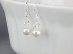 Swarovski pearl dangle bridal earrings.  Wedding jewelry for bride and bridal party by Celebrating Together.  #wedding #bridesmaid #bride #wedding jewelry #bridaljewelry #bridalearrings White Pearl Charm Drop Earrings For Bridal, White Dangle Bridal Earrings With Pearl Charm, White Pearl Charm Drop Bridal Earrings, White Nickel-free Dangle Pearl Earrings, Simple Bridal Jewelry, Pearl Drop Earrings Bridal, 14k Gold-filled Pearl White Dangle Pearl Earrings, Unique Bridal Jewelry, Wedding Jewelry For Bride