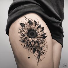 a woman's thigh with a sunflower tattoo on it