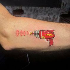 a man with a tattoo on his arm that has a rocket ship drawn on it