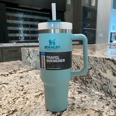 a blue travel mug sitting on top of a counter