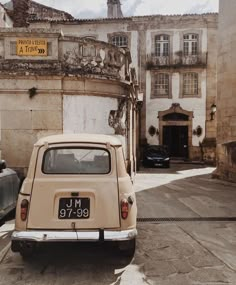 an old car parked in front of a building