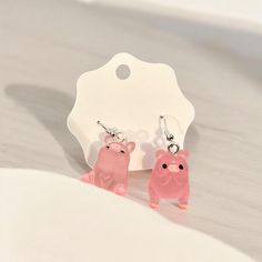 Cute Resin Pink Pig Earrings. These Earrings are not very heavy and so cute. This Listing is for the one set of Pig Earrings  that are Pictured. These are perfect for a cute Gift or Christmas Stocking Stuffer, a Pig Lover, Animal Enthusiast or as a Statement Piece it will add some pizzazz your Outfit! Everyone will love these!! All items are handcrafted by me with special care and detail in every product. All items are made in a smoke-free, pet free home. I ship within 24 hours of purchase. I always combine the shipping fee for you. For larger orders, please contact me. I am happy to work with you! Thank you for supporting my small business! I individually craft each piece to be truly one of a kind with the highest quality resin, pigments, glitter and other art supplies. Because these are Cute Drop Clip-on Earrings For Gift, Cute Pink Hoop Earrings For Gift, Kawaii Dangle Earrings With Ear Wire, Kawaii Hypoallergenic Earrings As Gift, Kawaii Hypoallergenic Earrings For Gift, Novelty Pink Nickel-free Earrings, Hypoallergenic Kawaii Earrings As Gift, Kawaii Drop Earrings, Hypoallergenic Kawaii Earrings For Gifts