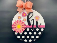 Add a touch of springtime cheer to your doorstep with our delightful 16" round Hi Daisy door hanger! Bursting with vibrant pink daisies and charming polka dot accents, this whimsical décor piece is sure to brighten up any space and welcome guests with a smile. Crafted with love and attention to detail, our door hanger is the perfect way to usher in the beauty of spring. Whether you're hosting a garden party or simply want to add a pop of color to your entryway, this eye-catching piece is sure to make a statement. Celebrate the arrival of warmer days with our Hi Daisy door hanger, and let your home bloom with happiness! Order yours today and add a touch of floral charm to your surroundings. Adorned with a charming coral pink bow and a translucent pink ribbon hanger, this 16" round door sign Pink Daisies, Round Door, Whimsical Decor, Pink Daisy, Door Signs, Pink Ribbon, Coral Pink, Pink Bow, Door Hanger